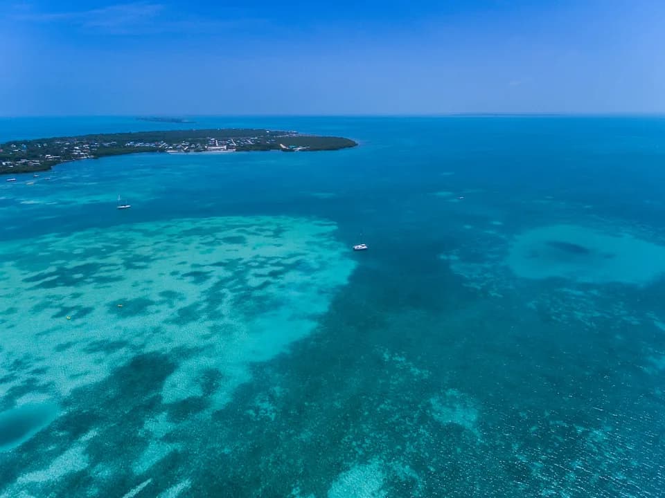 An aerial view of the turquoise reef around Caye Caulker, Belize